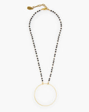 Frisco, TX Delicate brass circle is suspended from delicate micro crystal chain. Booster, Julio Designs