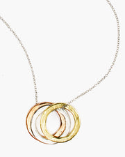 Erie Triple Ring Necklace. A trio of tri-tone hammered rings float on delicate chain. Handmade in Frisco 