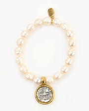 Fairy Pearl Stretch Bracelet. Pewter coin charm set in a rustic bezel is suspended from a natural freshwater pearl stretch bracelet. The coin in our Fairy Bracelet is a replica of the Spanish "pieces of eight" coin.