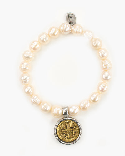 The coin in our Fairy Bracelet is a replica of the Spanish "pieces of eight" coin. Fairy Pearl Stretch Bracelet. Pewter coin charm set in a rustic bezel is suspended from a natural freshwater pearl stretch bracelet.