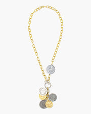 Gravity Toggle Front Coin Necklace, A quintet of coins from across the globe cascade from a toggle clasp on textured chain. Handmade in Frisco, Texas. Julio Designs. The gravity necklace is a versatile necklace to accent any look.