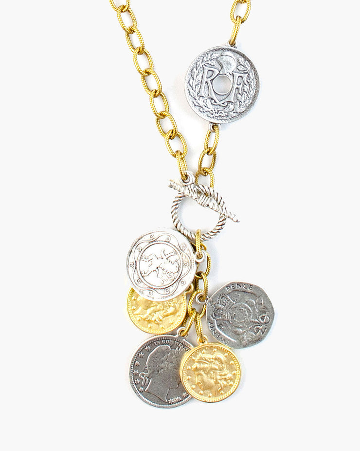 Gravity Toggle Front Coin Necklace, A quintet of coins from across the globe cascade from a toggle clasp on textured chain. The gravity necklace is a versatile necklace to accent any look. Handmade in Frisco, Texas. Julio Designs