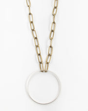 A brass circle is suspended from paperclip chain. Kit Kat Paperclip Chain Circle Necklace Beautiful on its own or layered, the Kit Kat Necklace is sure to become one of your go-to favorites. 