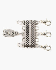 Handmade in Frisco, Texas. Julio Designs Create your own layered look necklace party! Our MLC Magnetic Layering Clasp makes layering a tangle-free breeze. Simply attach your 3 favorite necklaces to the MLC and clasp everything in a snap! Great for organizing your necklaces when travelling, too. 