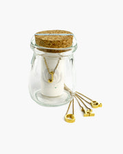 Dimensional lowercase gold initial charm on delicate chain.  Packaged in a 2.5" tall glass bottle with cork stopper. The Spice initial necklace is the perfect ready-to-go gift! Handmade in Frisco TX, Julio Designs