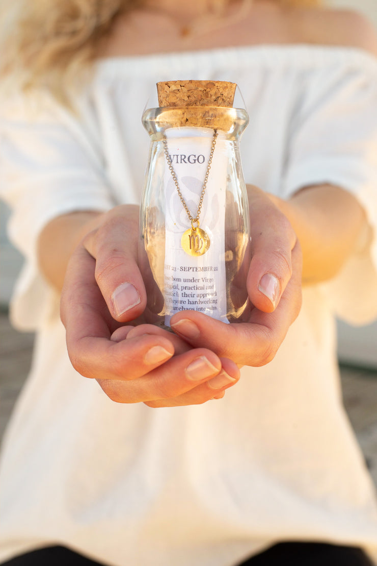 The Zodiac sign necklace is the perfect ready-to-go gift! Handmade in Frisco TX, Julio Designs Bottled golden Zodiac symbol necklace on delicate chain.  Packaged in a 4" tall glass bottle with cork stopper.